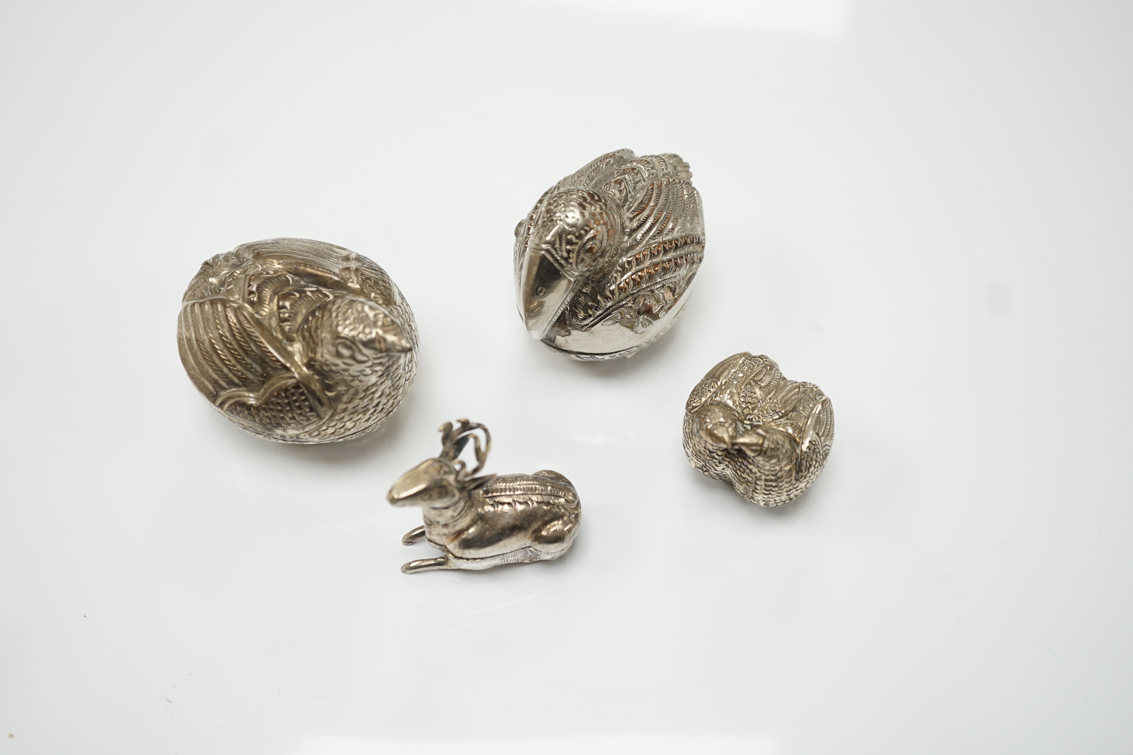Four South East Asian white metal small ‘animal’ boxes. Largest 6cm